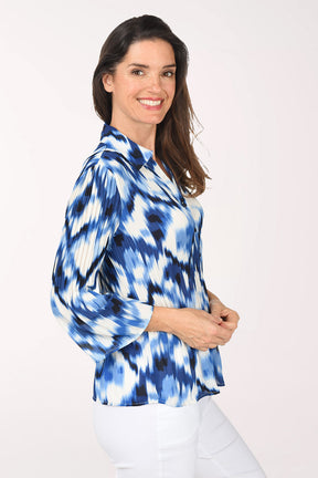 Woman wearing a blue and white tie-dye shirt on a white background