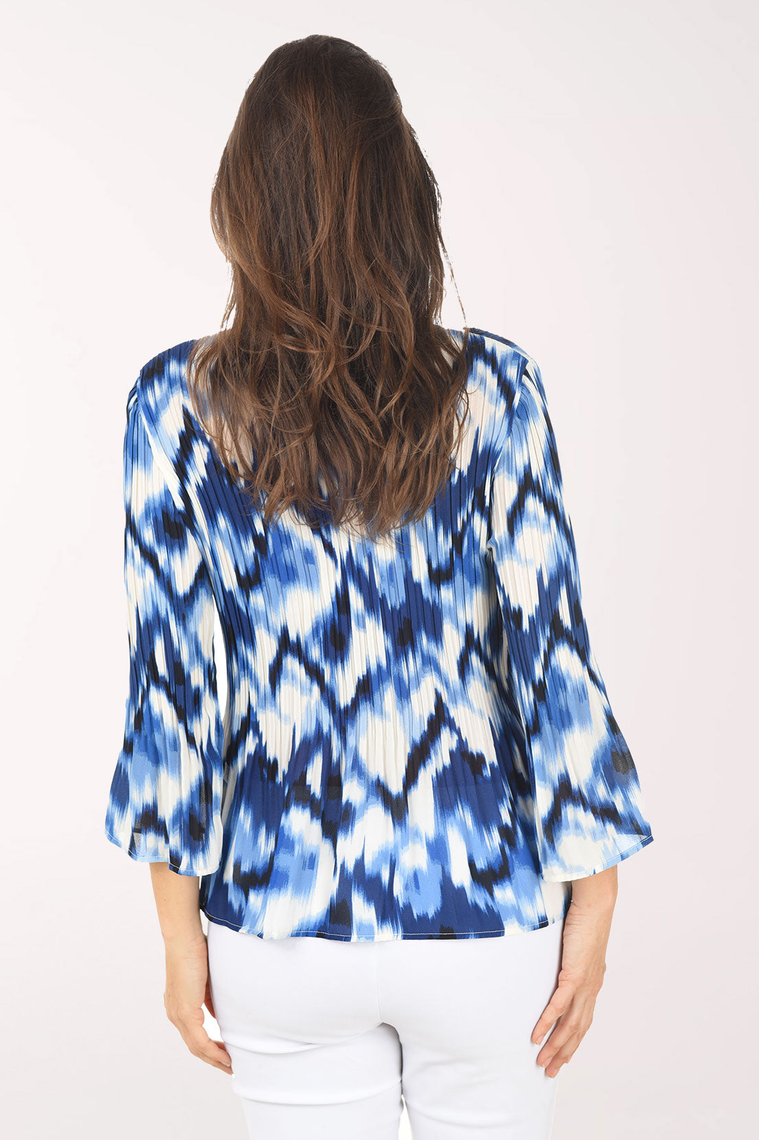 Woman wearing a blue and white tie-dye shirt on a white background