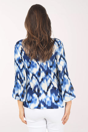 Woman wearing a blue and white tie-dye shirt on a white background