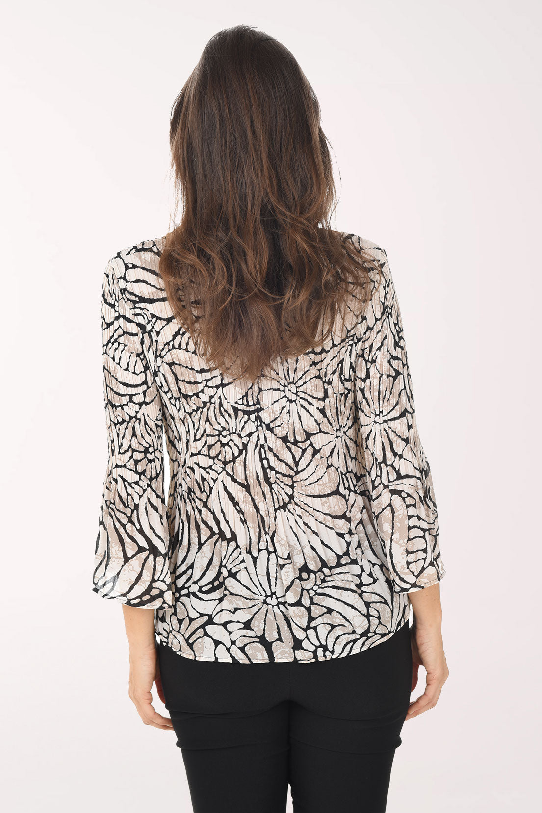 Woman wearing a patterned blouse on a white background