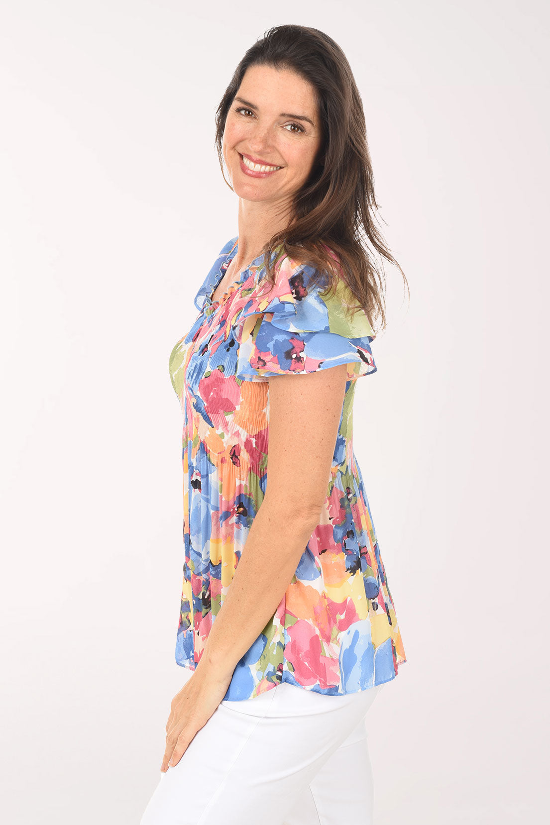 Woman wearing a colorful floral blouse on a white background