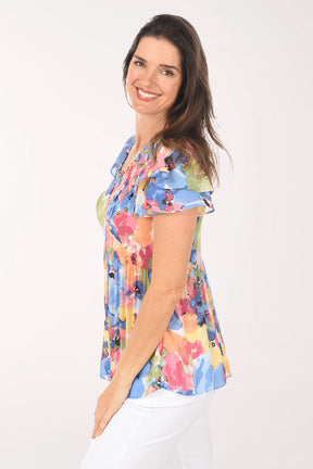 Woman wearing a colorful floral blouse on a white background