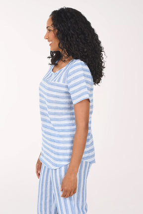 Woman wearing a blue and white striped pajama set on a white background