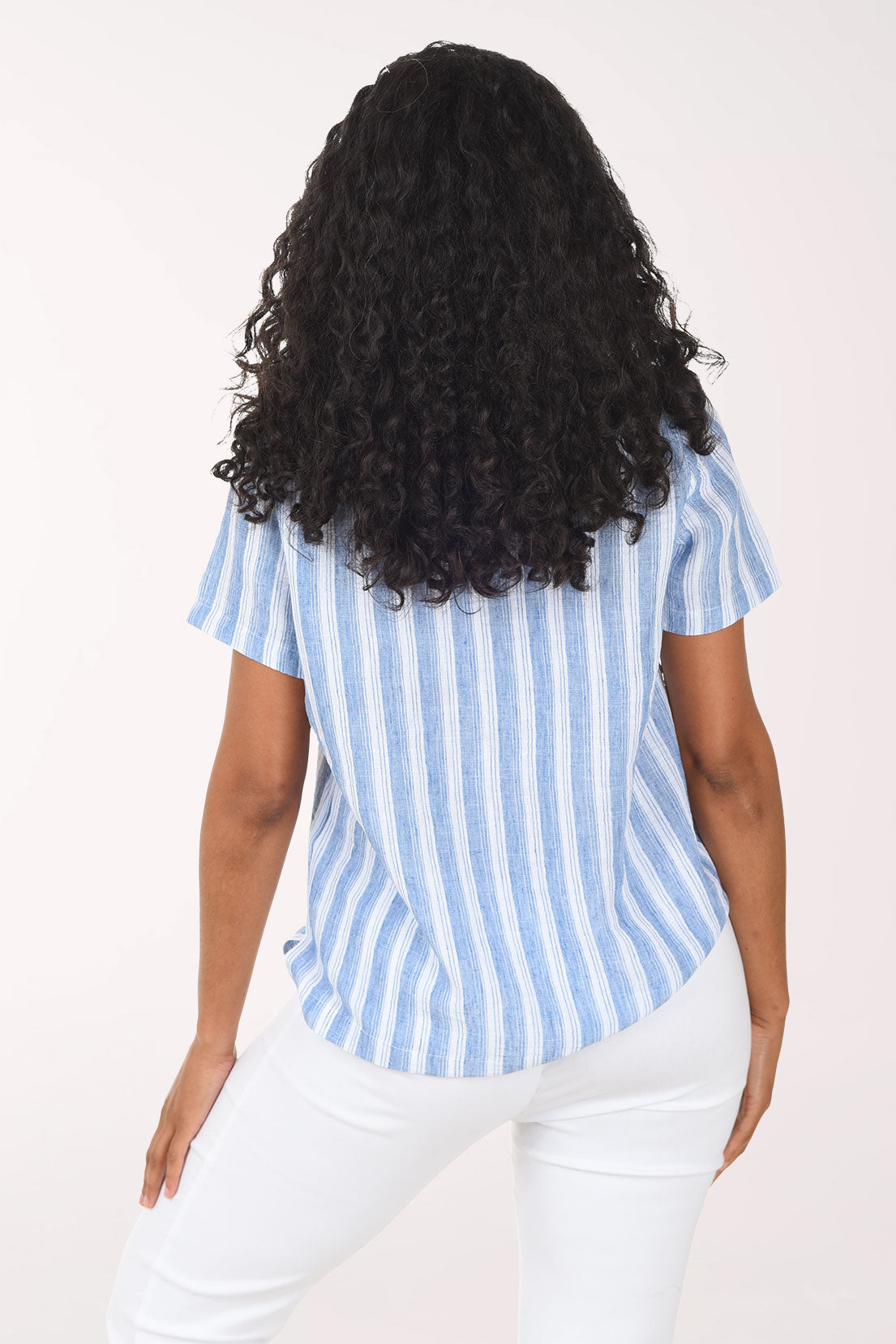 Woman wearing a blue and white striped shirt on a white background