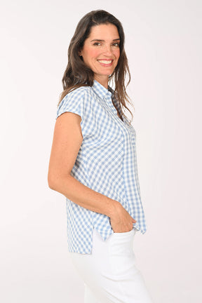 Woman wearing a blue and white gingham collared top