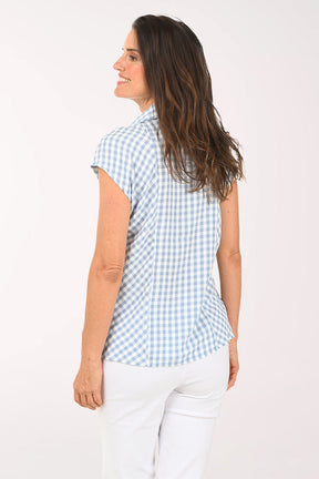 Woman wearing a blue and white gingham collared top
