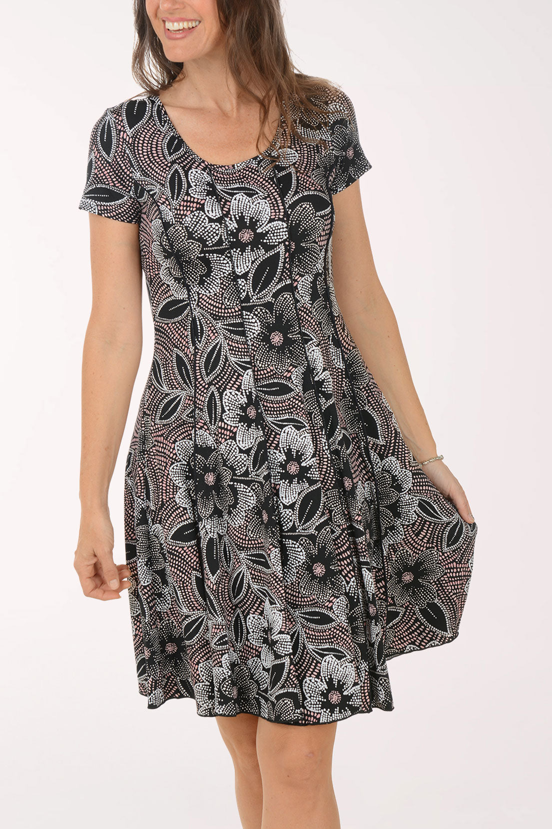 Woman wearing a patterned dress on a white background