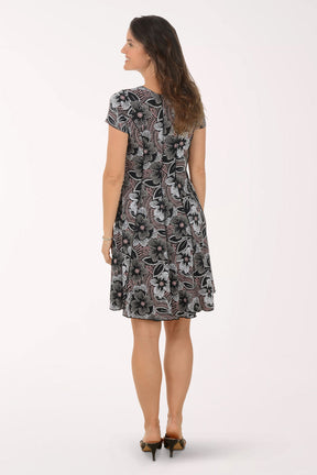 Woman wearing a patterned dress on a white background