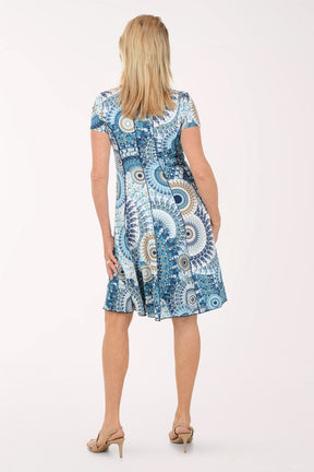 Woman wearing a blue and white patterned dress on a white background