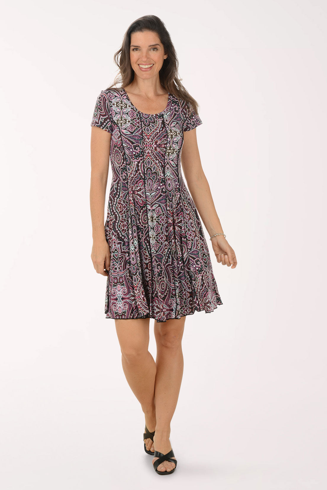 Woman wearing a patterned dress on a white background