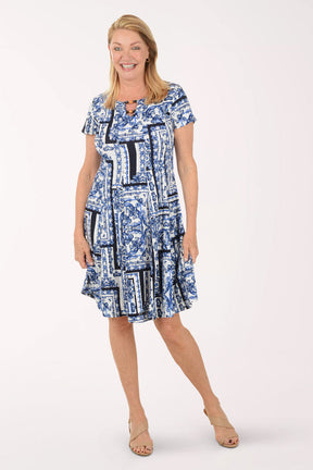 Woman wearing a blue patterned dress on a white background