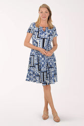 Woman wearing a blue patterned dress on a white background