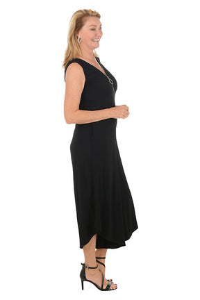 Woman wearing a black sleeveless jumpsuit with a zipper on a white background. Side shot.