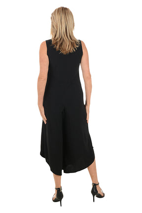 Woman wearing a black sleeveless jumpsuit with a zipper on a white background. Back shot.