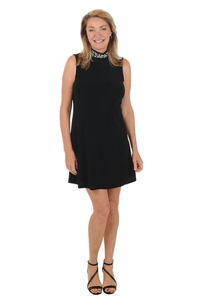 Woman wearing a black dress on a white background.