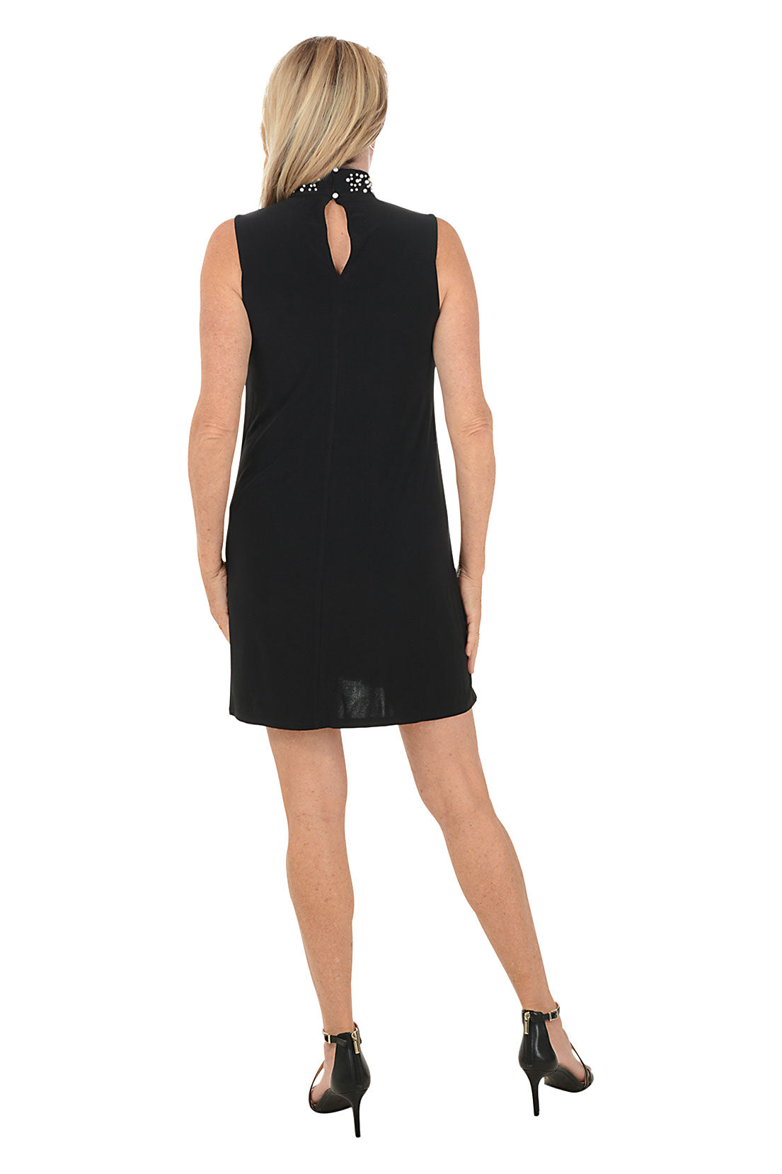 Woman wearing a black dress on a white background. Back shot.