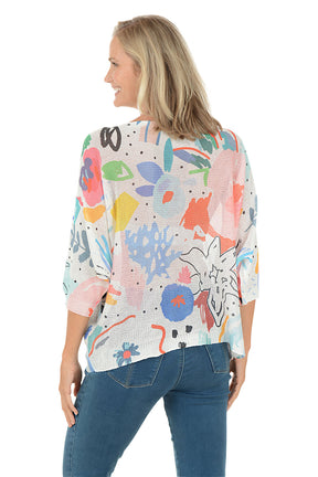 Woman wearing a colorful abstract patterned top on a white background. Back shot.