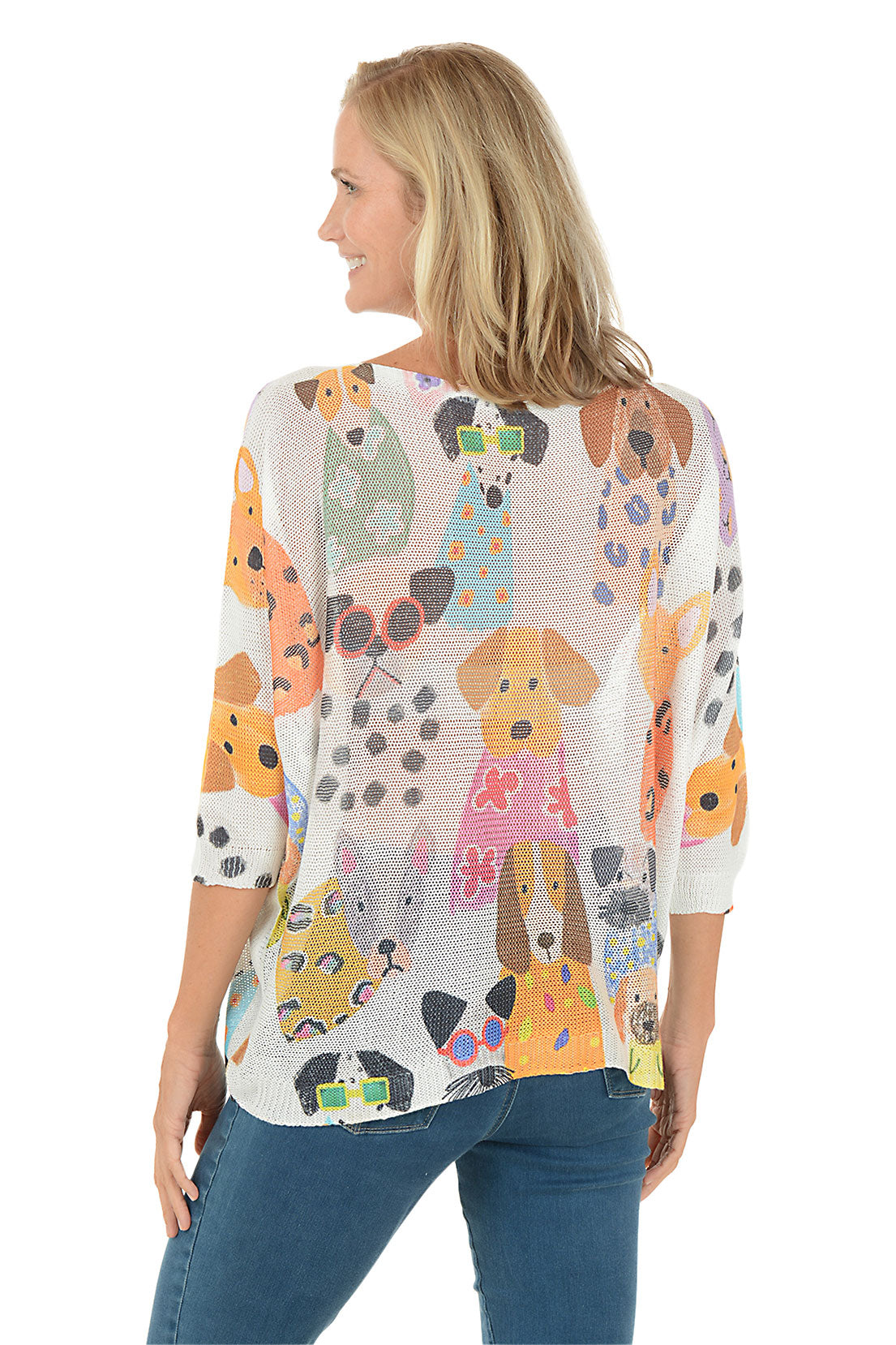 Woman wearing a colorful dog-patterned shirt on a white background. Back shot.