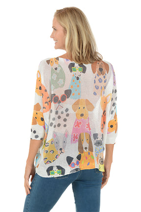 Woman wearing a colorful dog-patterned shirt on a white background. Back shot.