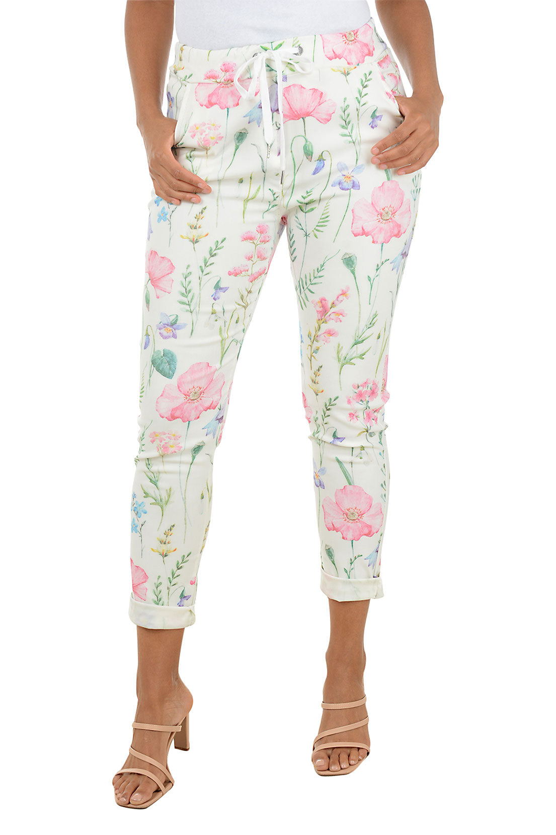 Floral jogger pants worn by a person on a white background.