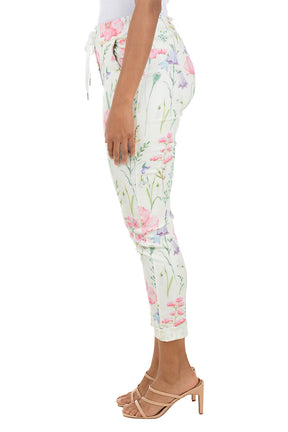 Floral jogger pants worn by a person on a white background. Side shot.