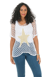 Woman wearing a white mesh top with a star design and blue jeans on a white background.