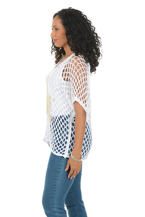 Woman wearing a white mesh top with a star design and blue jeans on a white background. Side shot.