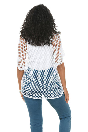Woman wearing a white mesh top with a star design and blue jeans on a white background. Back shot.