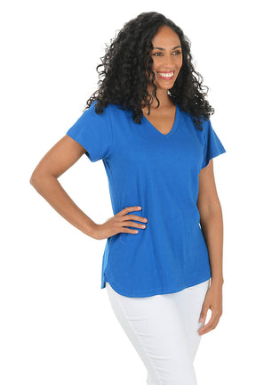 Woman wearing a blue t-shirt and white pants on a white background