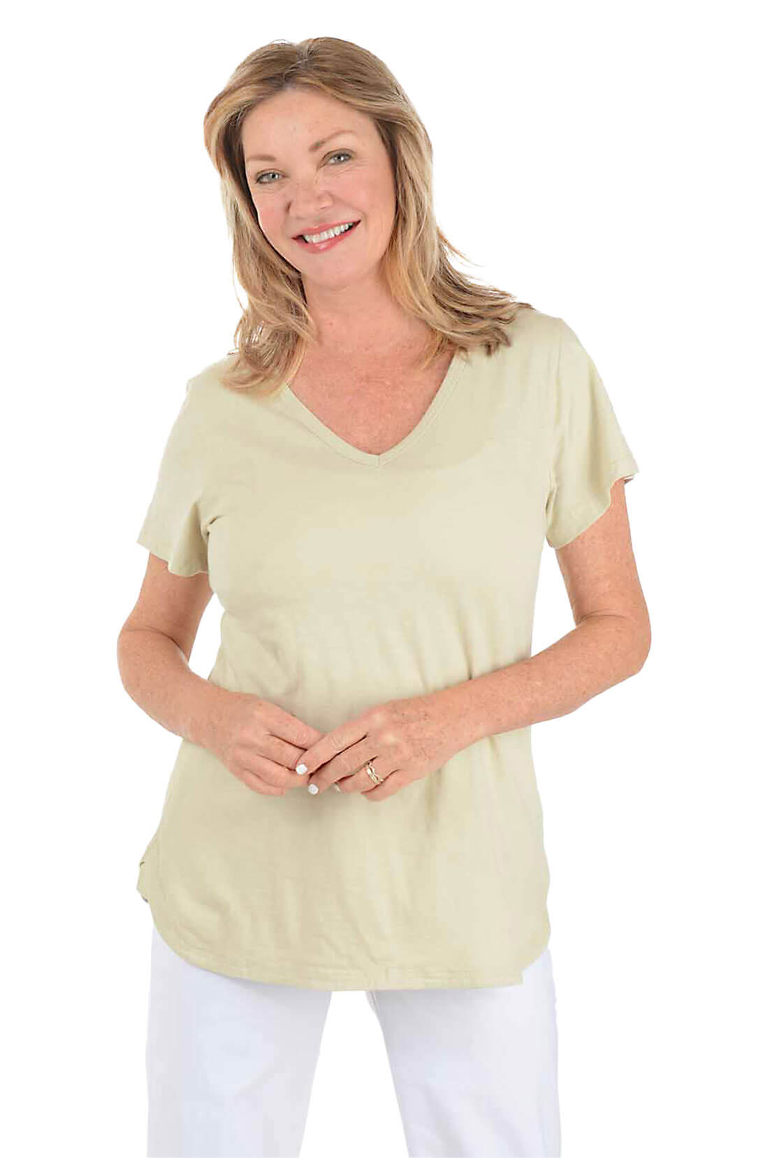 Woman wearing a beige t-shirt and white pants on a white background