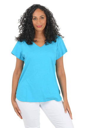 Woman wearing a blue t-shirt and white pants on a white background