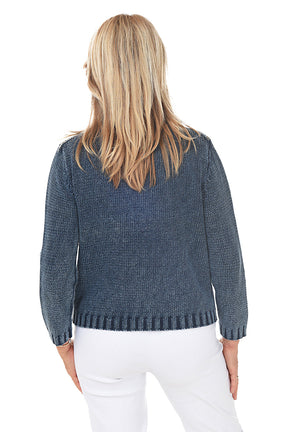 Woman wearing a blue denim sweater jacket on a white background. Back shot.