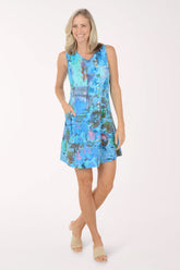 Woman wearing a blue patterned dress on a white background