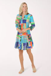 Woman wearing a colorful patterned dress on a white background