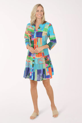 Woman wearing a colorful patterned dress on a white background