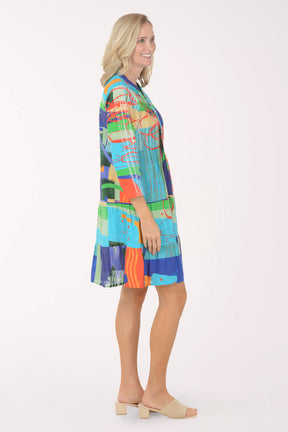 Woman wearing a colorful patterned dress on a white background