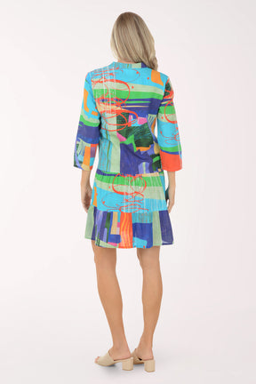 Woman wearing a colorful patterned dress on a white background