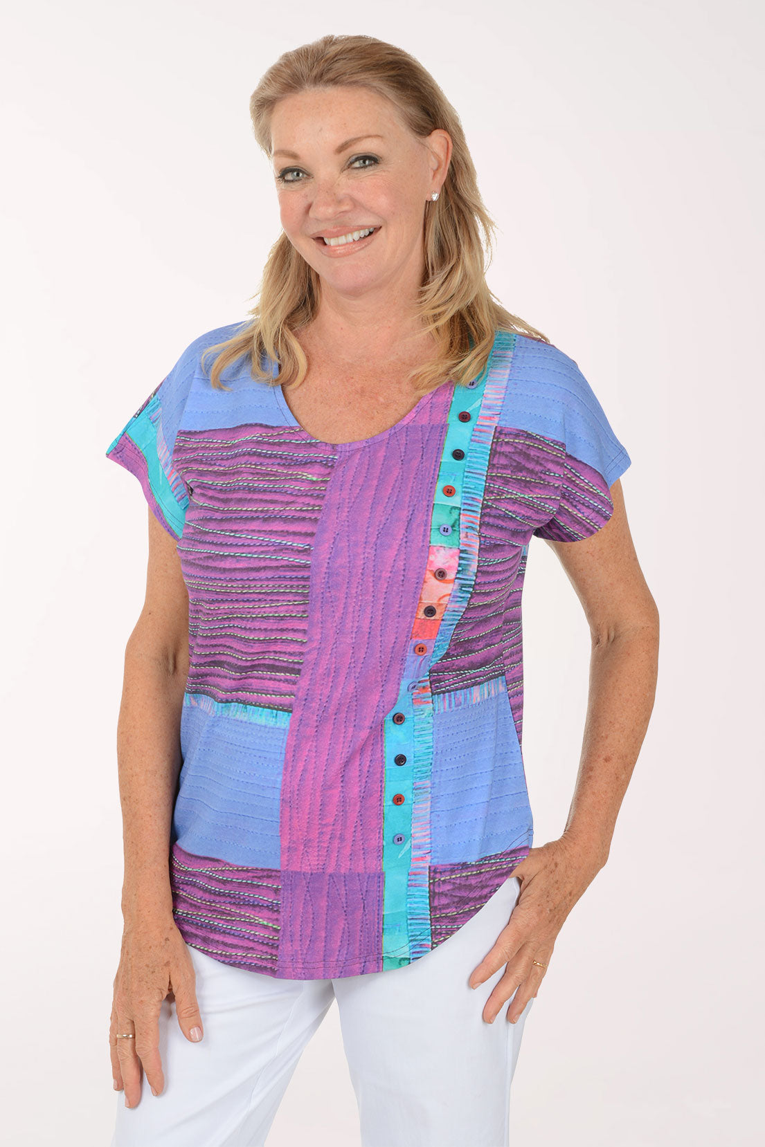 Woman wearing a colorful patterned top on a white background