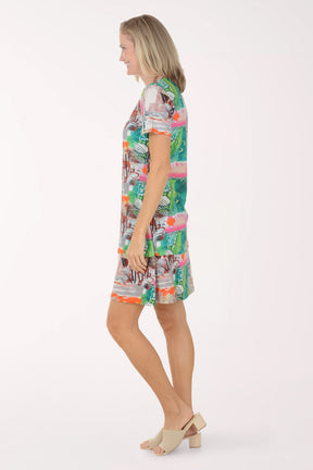 Woman wearing a colorful patterned dress on a white background