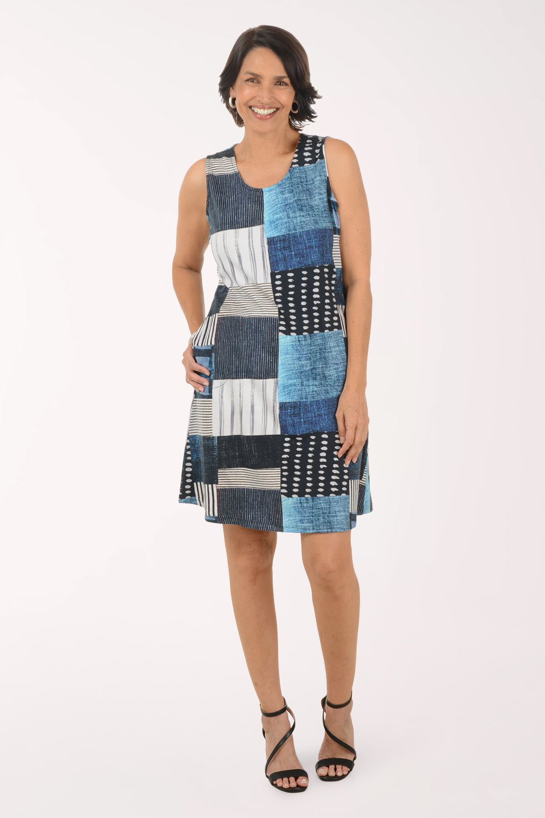 Woman wearing a patchwork dress with a white background