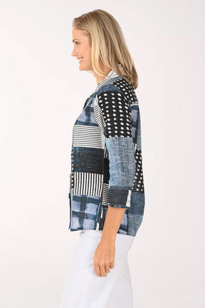 Woman wearing a patchwork shirt with a white background