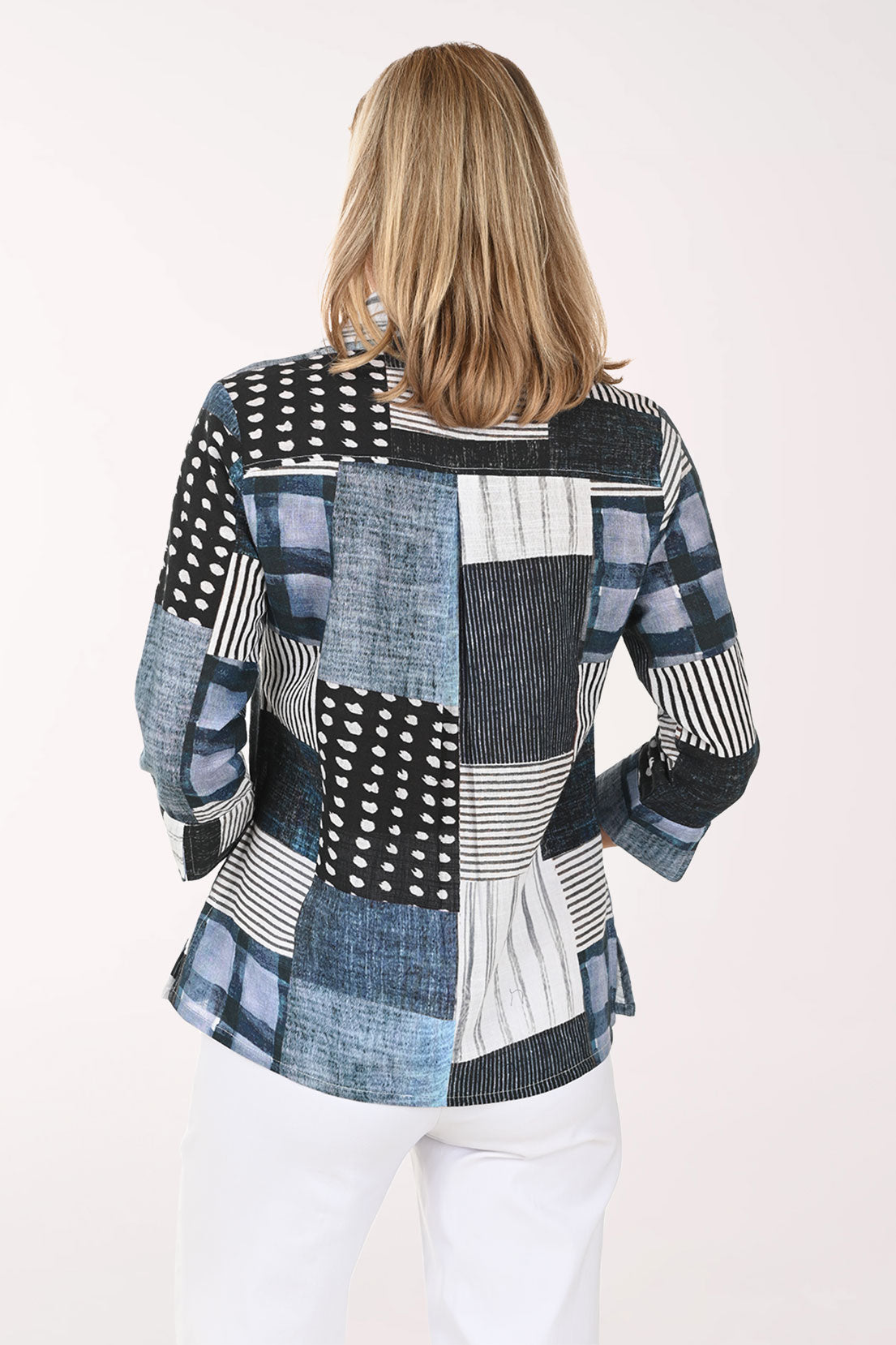 Woman wearing a patchwork shirt with a white background