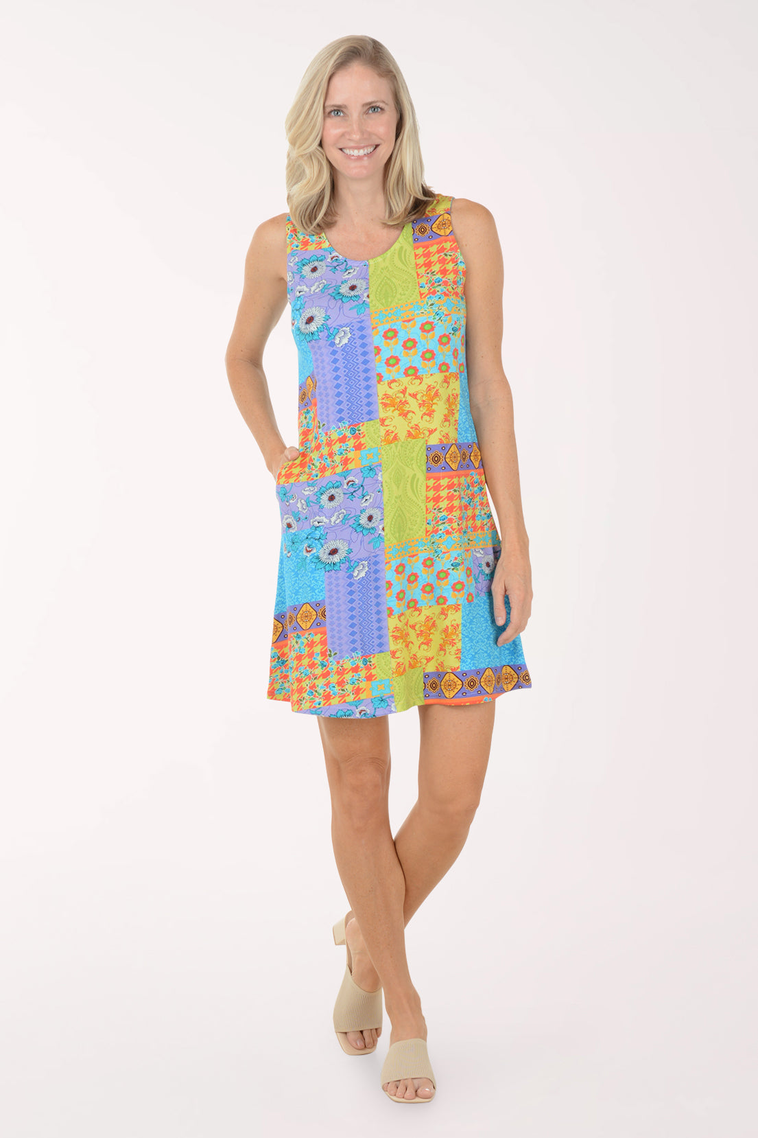 Woman wearing a colorful patchwork dress on a white background