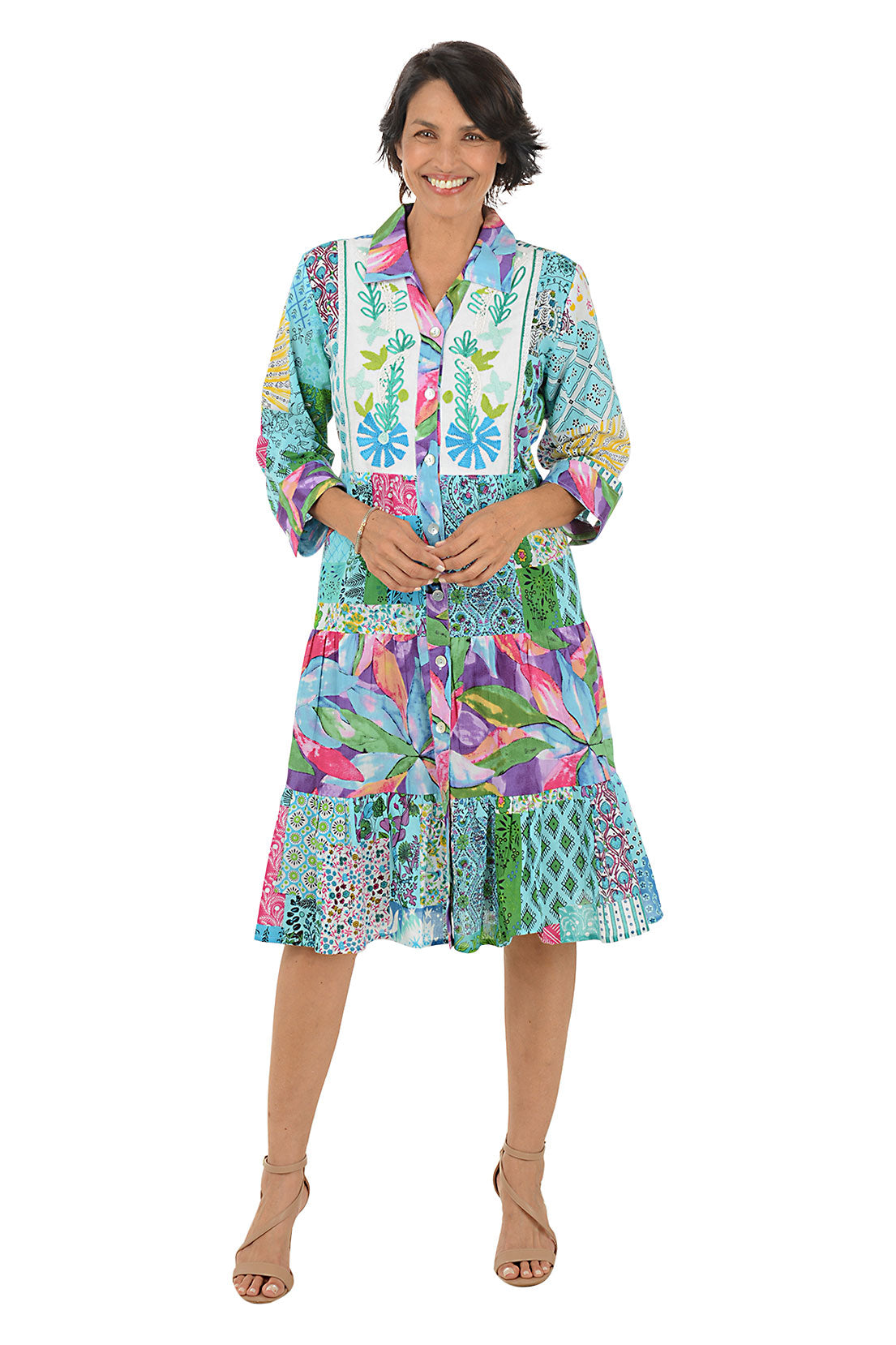 Woman wearing a colorful patterned dress on a white background