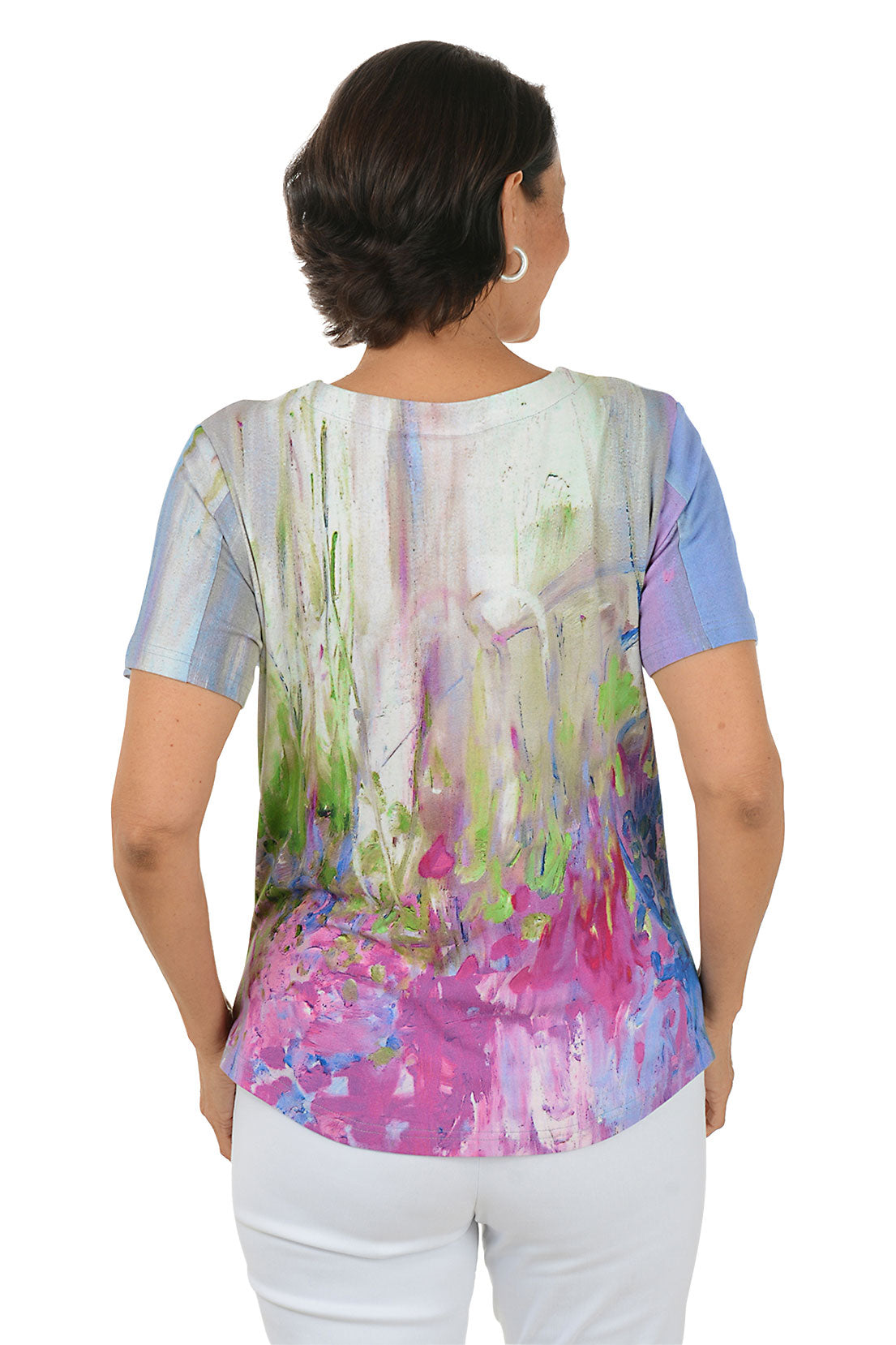 Woman wearing a colorful abstract patterned top on a white background. Back shot.