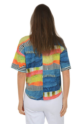Woman wearing a colorful patterned shirt on a white background