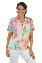 Woman wearing a colorful short-sleeve top with a white background
