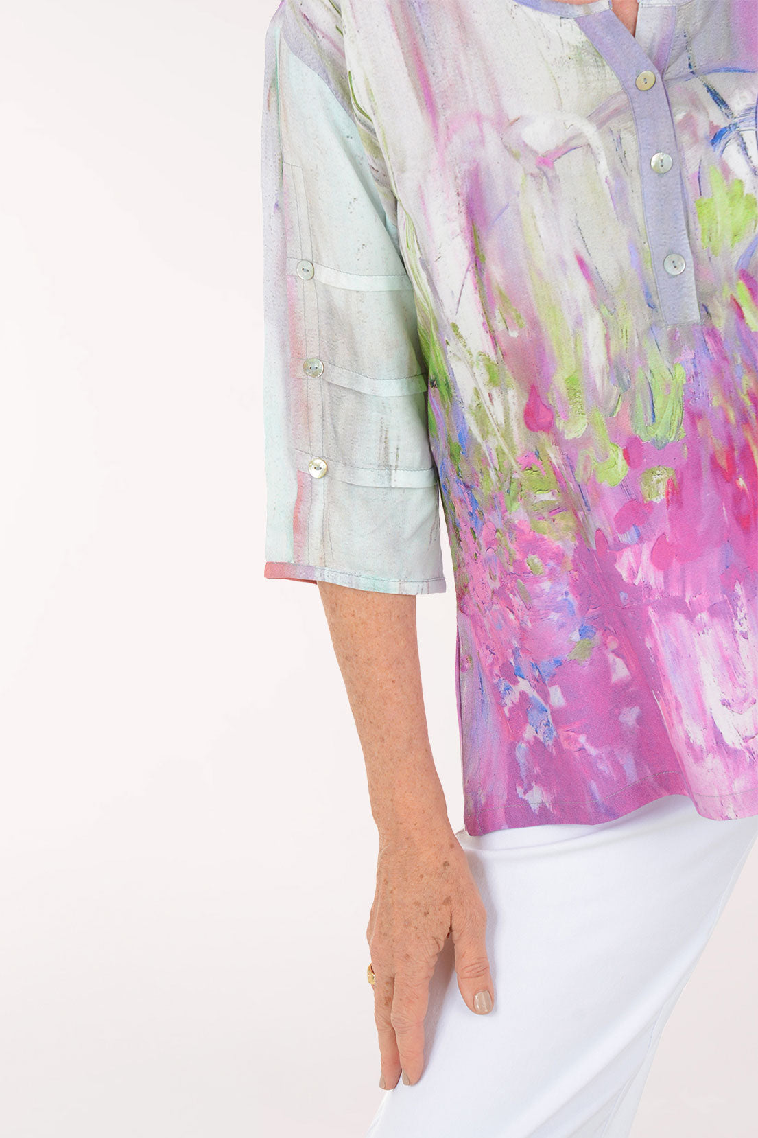 Woman wearing a colorful blouse with abstract design on a white background