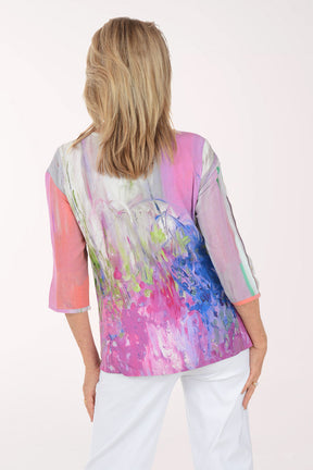 Woman wearing a colorful blouse with abstract design on a white background