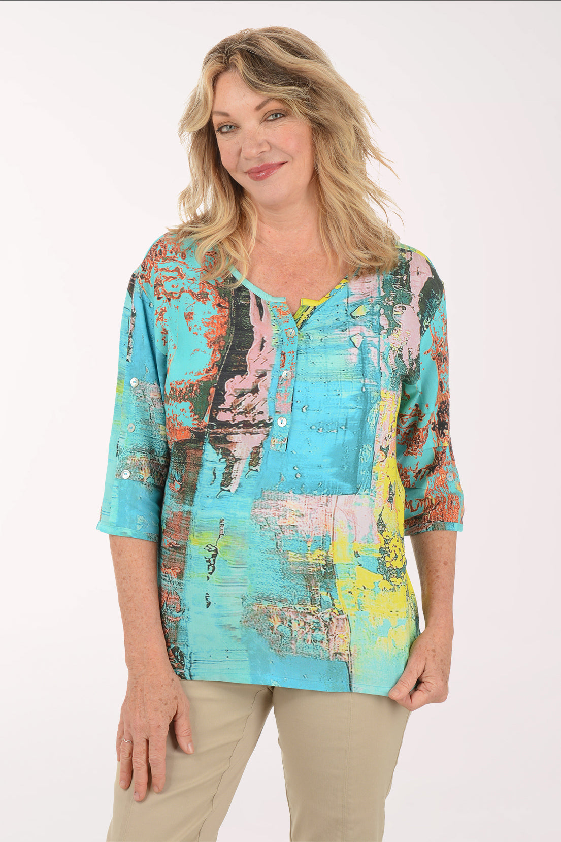 A woman wearing a multicolored blue top.